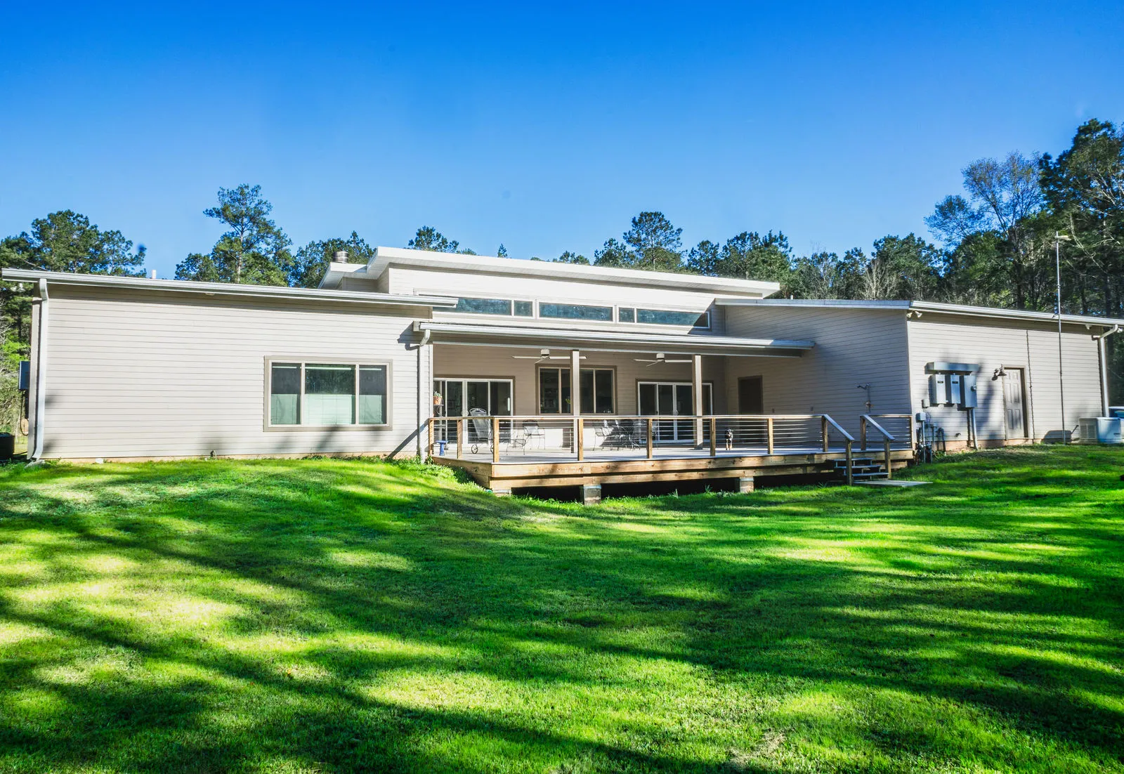 Long, modern custom home with expansive lawn