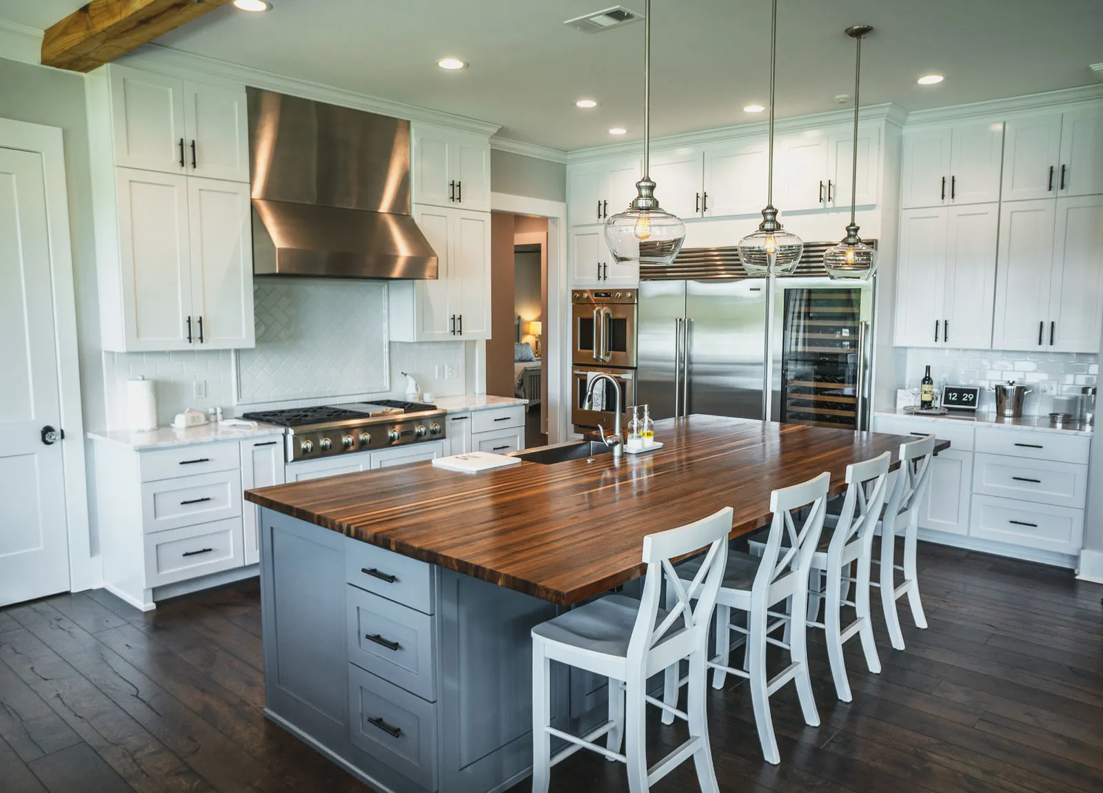 Custom kitchen with large island, bar stools, and copper hood